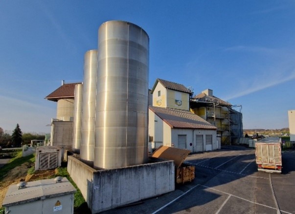 Exterior view of a modern agricultural feed processing plant with silos, part of the BAG Life Cycle Assessment (LCA) study 2025 in Austria