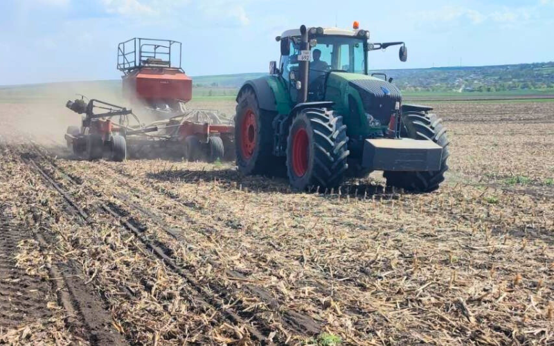 Tractor on a demo field in Moldova preparing land for soya and legume cultivation using no-till technology