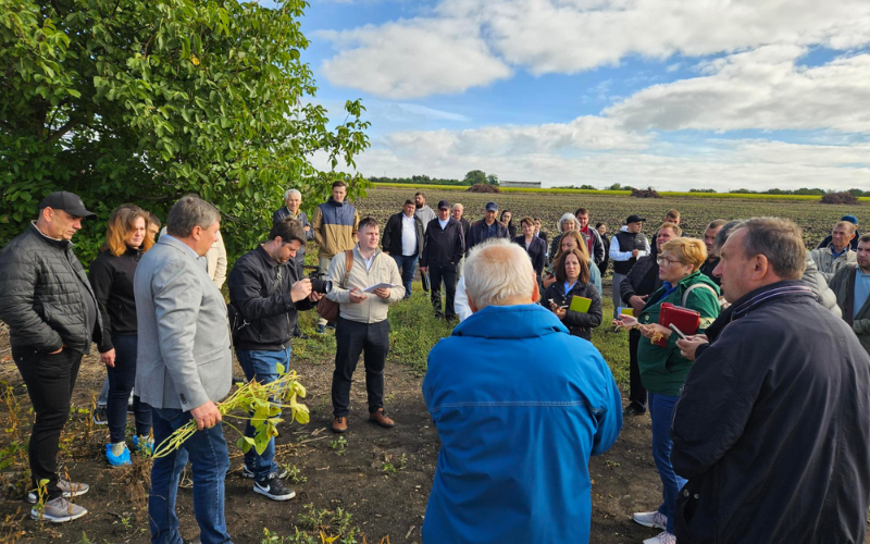 Group of farmers and stakeholders in a Moldovan soybean field during Donau Soja seminar on bioeconomic potential and climate change.