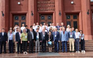 Forum participants pose on the steps outside the Academy of Sciences of Moldova.